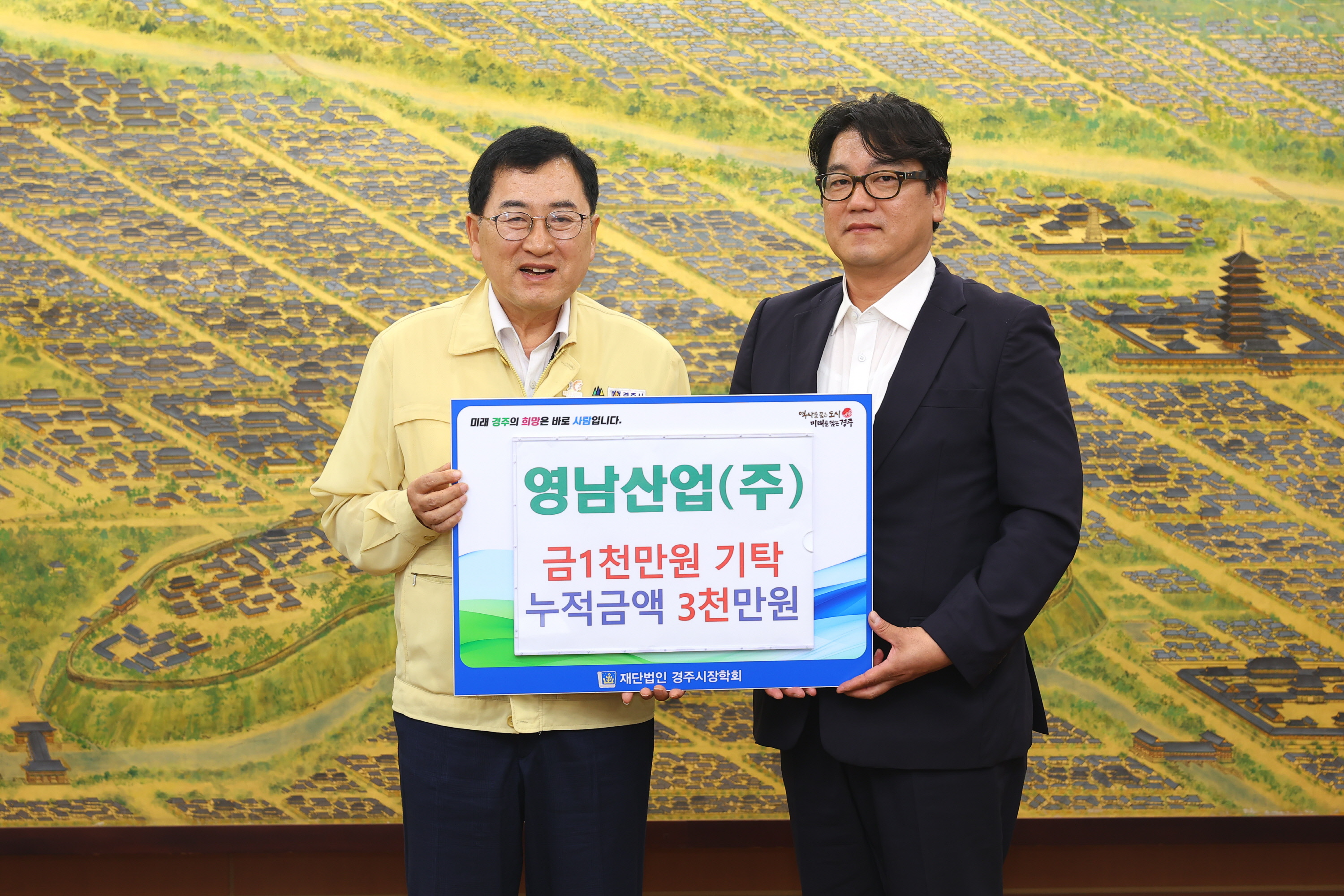 영남산업㈜ 최용환(오른쪽) 대표가 20일 경주시청을 방문해 주낙영 경주시장에게 장학금 1,000만 원을 전달한 후 기념촬영을 하고 있다.