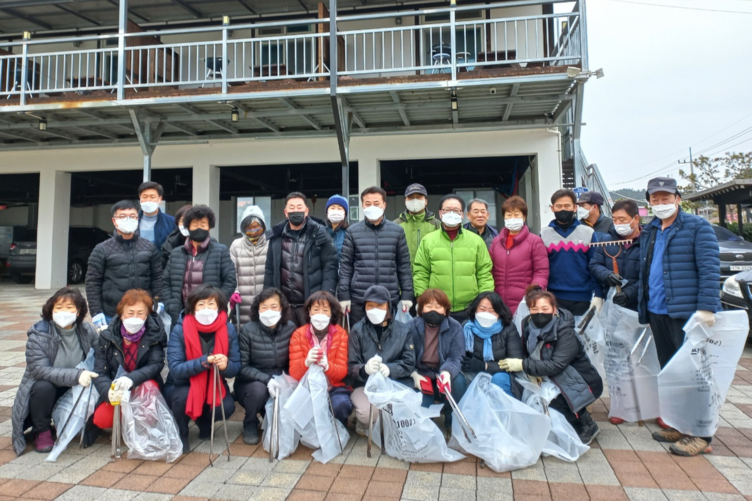 경주시 북군동 설맞이 대청소에 참여한 펜션연합회 회원 및 주민들이 기념촬영을 하고 있다