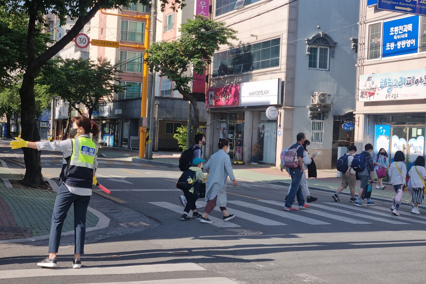 3. 경주시 동천동 여성자율방범대 대원이 동천초등학교 인근 횡단보도에서 등교하는 학생들을 위해 교통사고예방 활동을 하고 있다.jpg