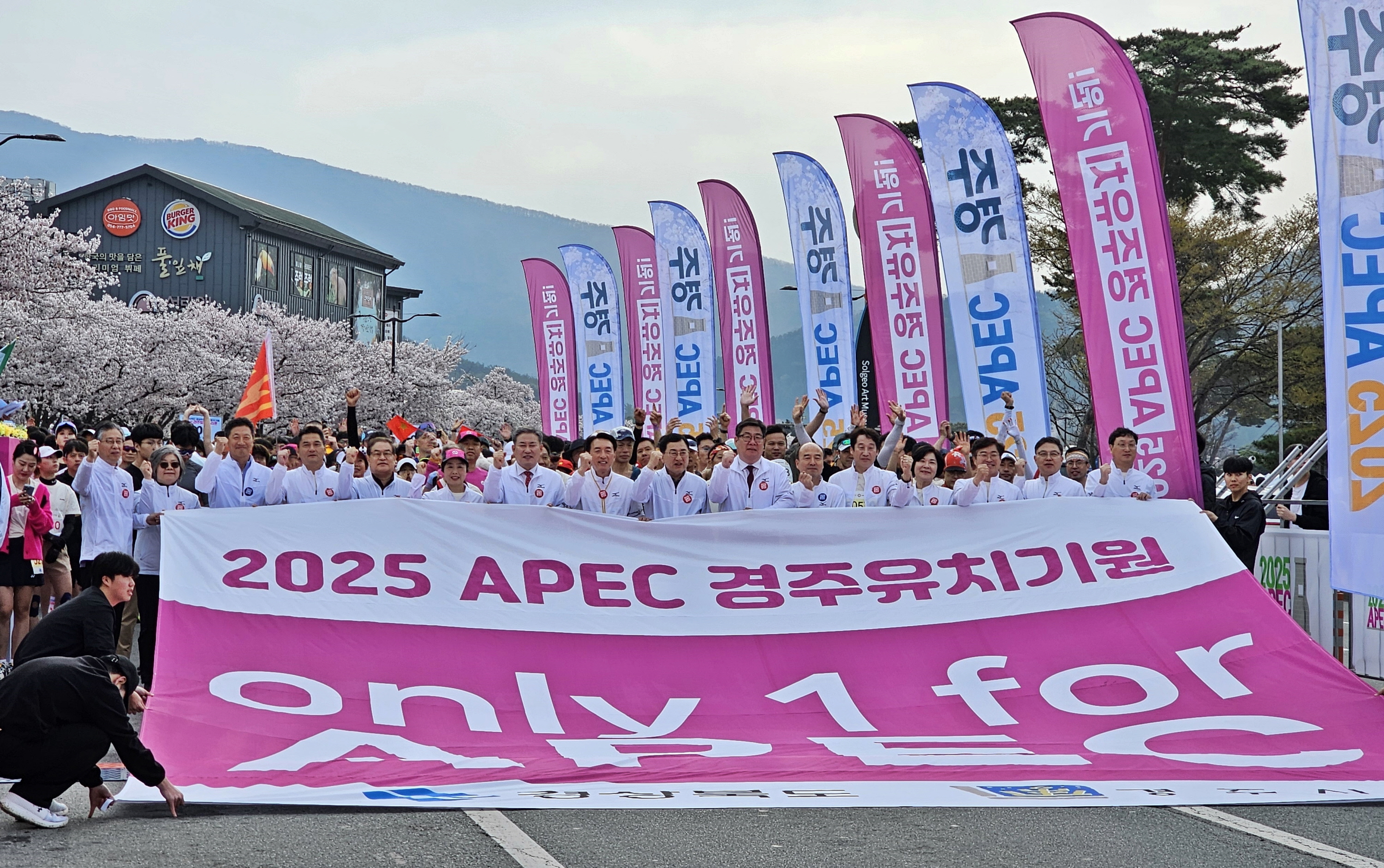 지난 6일 경주보문관광단지에서 열린 ‘제31회 경주벚꽃마라톤대회’에 참가한 시민과 관광객들이 2025 APEC 경주유치기원 퍼포먼스를 하고 있다.